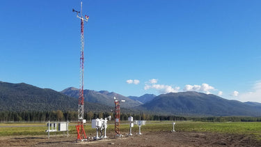 Mesotech AWA Automated Weather Observing System AWOS IIIPT airport weather station in a lush mountain landscape.